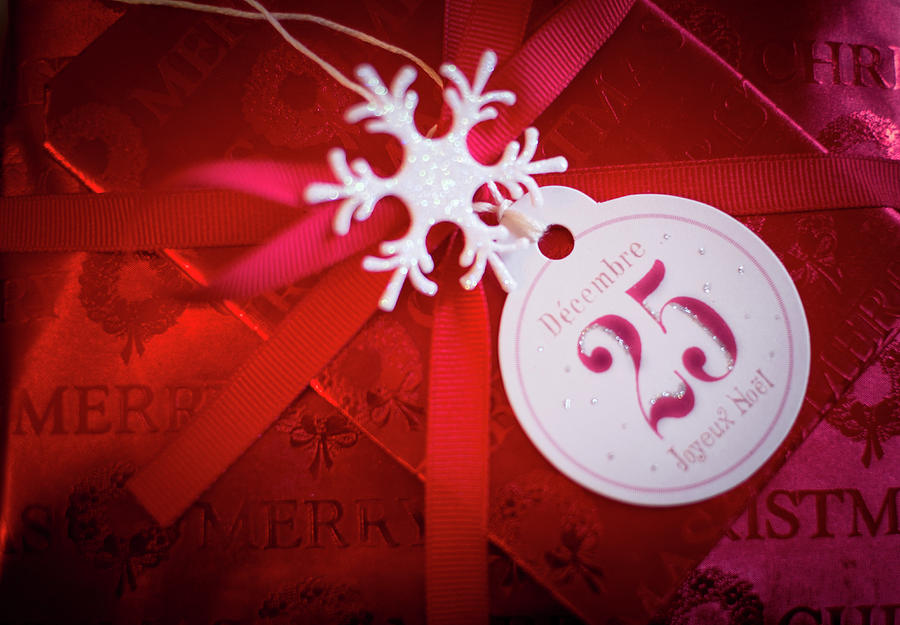 Christmas Present Wrapped In Red Paper With Tag Photograph by Eising Studio