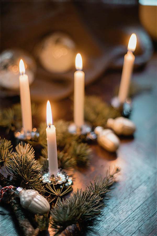 Christmas Table Decorations With Sprigs Of Pine And Lit Candles Photograph by Pia Simon