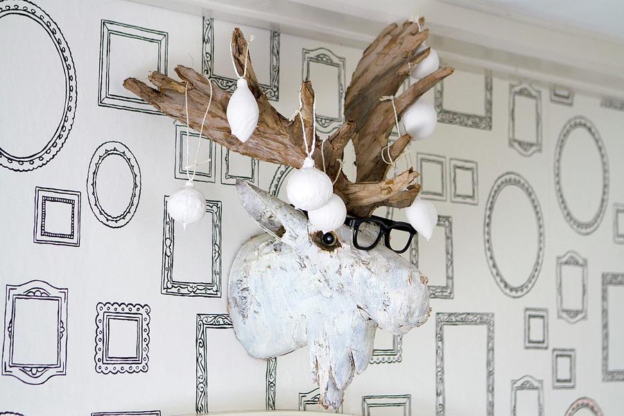 Christmas-tree Baubles Dipped In Plaster And Hung From Fake Moose Head On Wall Photograph by Olga Serrarens