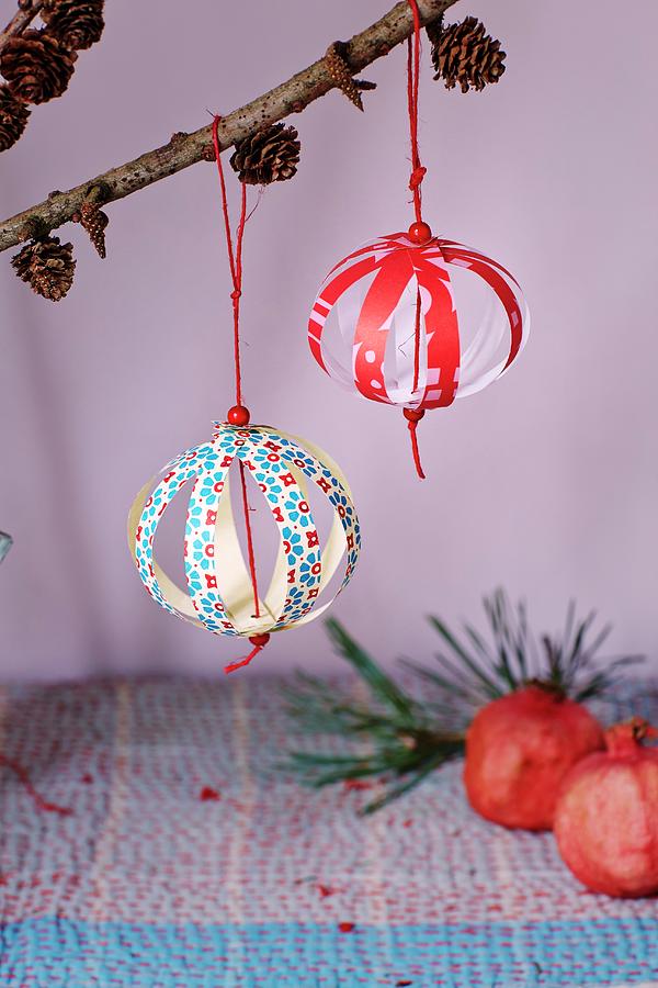 Christmas-tree Baubles Made From Paper Strips Hung From Larch Branches Photograph by Martin Slyst