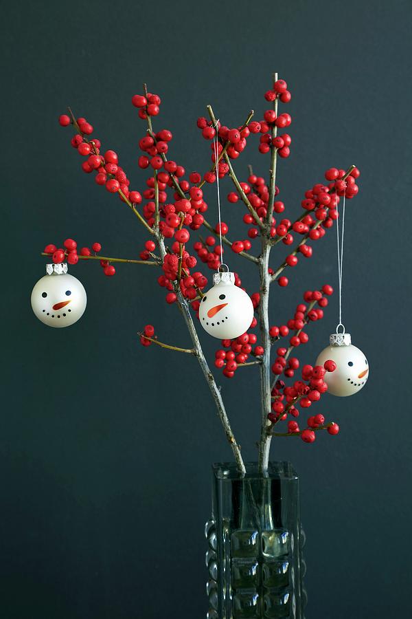 Christmas Tree Baubles With Snowmans Faces Hanging On Branches Of Red Holly Berries ilex Photograph by Lioba Schneider Fotodesign