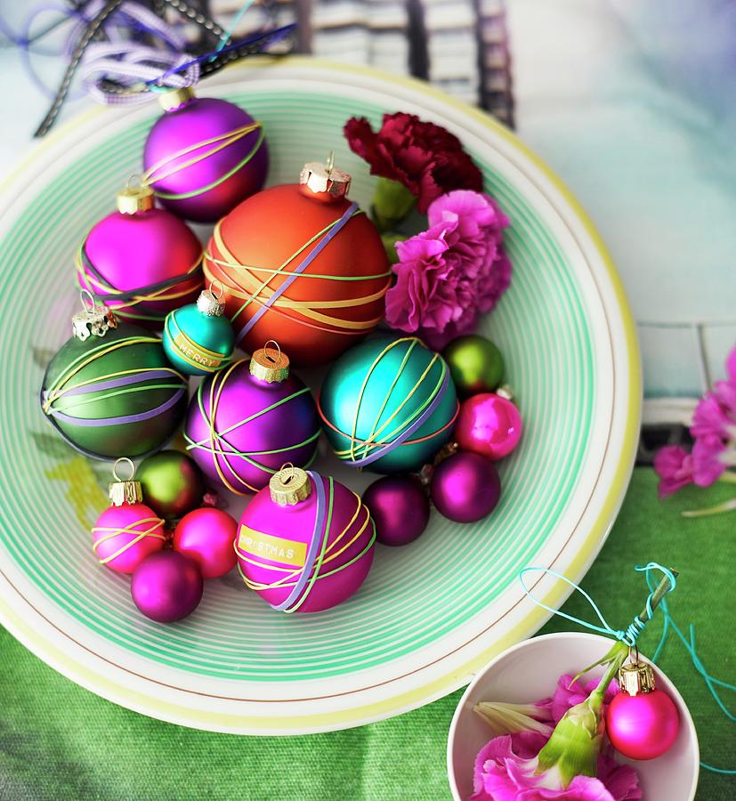 Christmas Tree Baubles Wrapped With Colourful Rubber Bands Decorating Table Photograph by Andreas Hoernisch