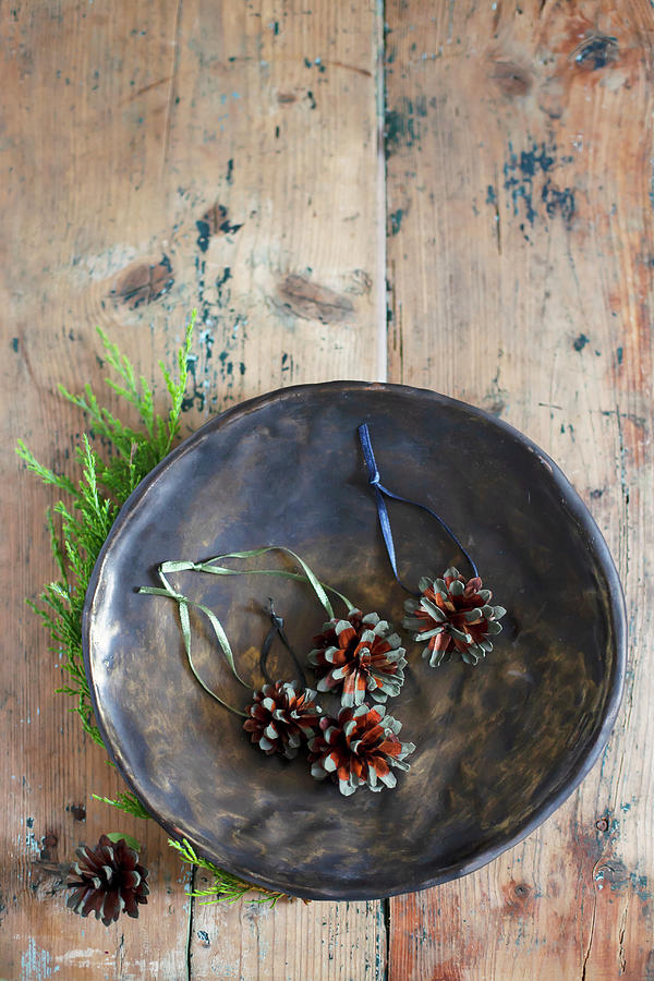 Christmas-tree Decorations Made From Pine Cones In Bowl Photograph by Alicja Koll