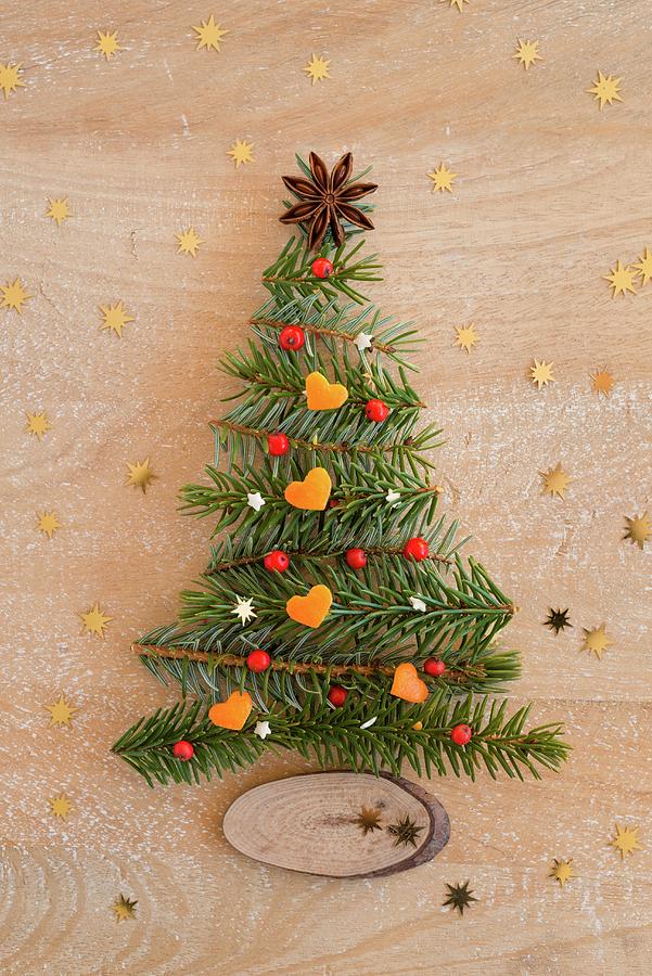 Christmas Tree Made From Fir Twigs Laid On Wooden Surface Photograph by Sonia Chatelain