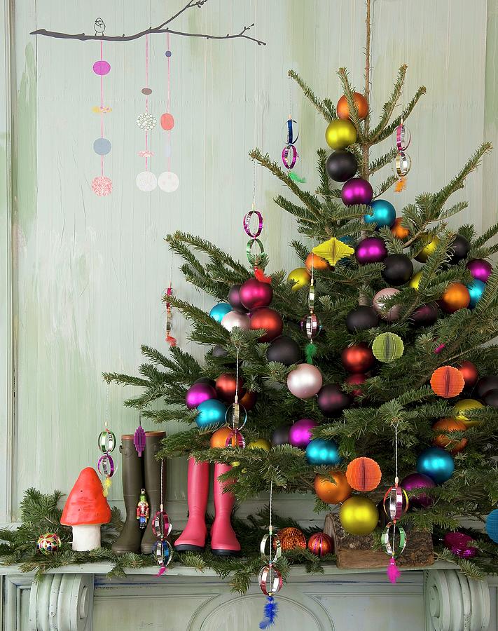 Christmas Tree With Multicoloured Baubles, Wellington Boots And Festive Ornaments On Mantelpiece Photograph by Frederic Vasseur