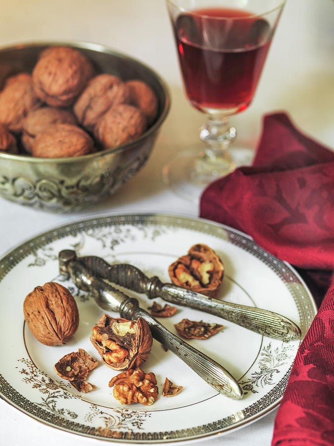 Christmas Walnuts Cracked Open On Plate With Nut Cracker And Red Wine Photograph by Michael Paul