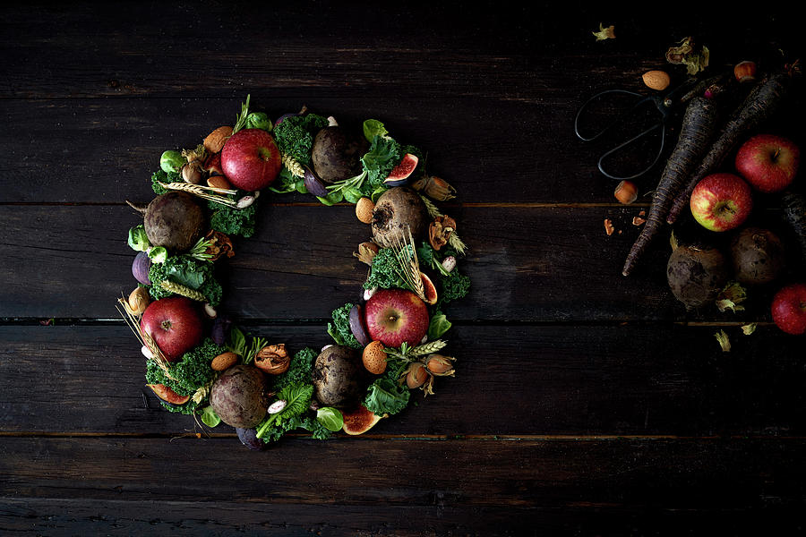 Christmas Wreath Of Apples And Vegetables Photograph by Lina Eriksson