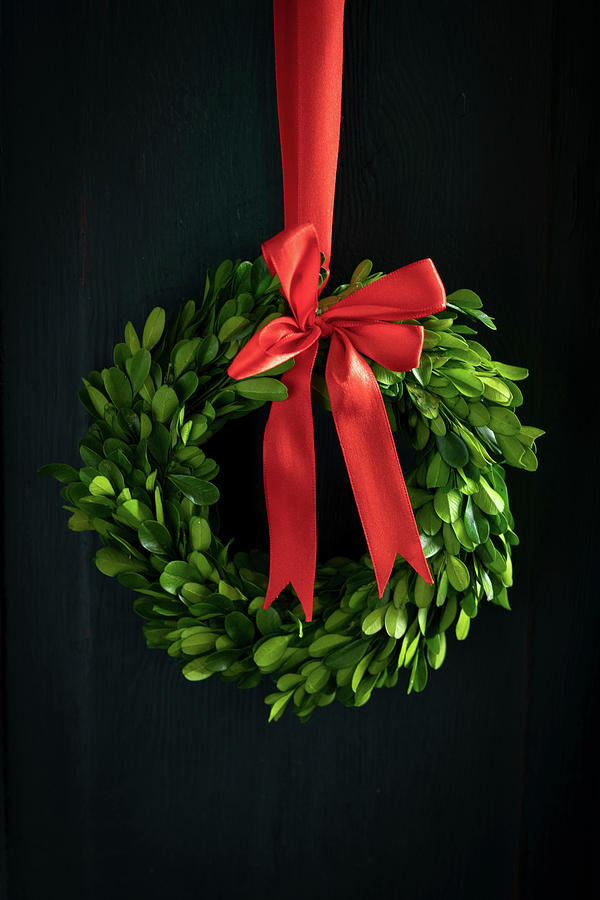Christmas Wreath Of Box Leaves With Red Bow Photograph by Eising Studio