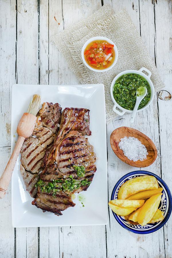 Churrasco Steak With Side Dishes criolla Sauce, Chimichurri Sauce And Potato Wedges Photograph by Maricruz Avalos Flores