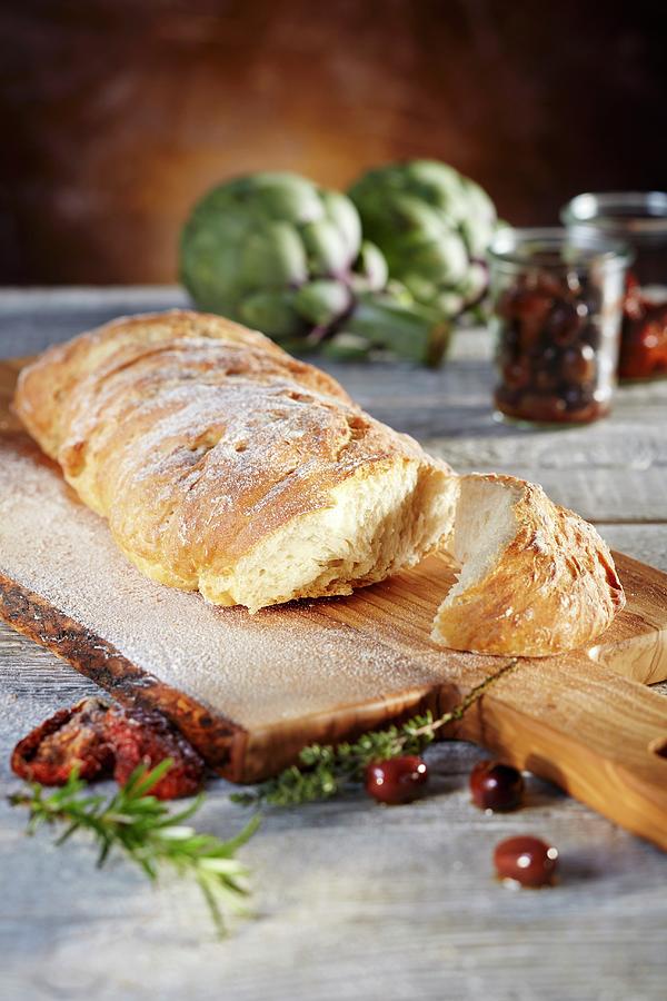Ciabatta Bread On An Olive Wood Board Photograph by Niklas Thiemann