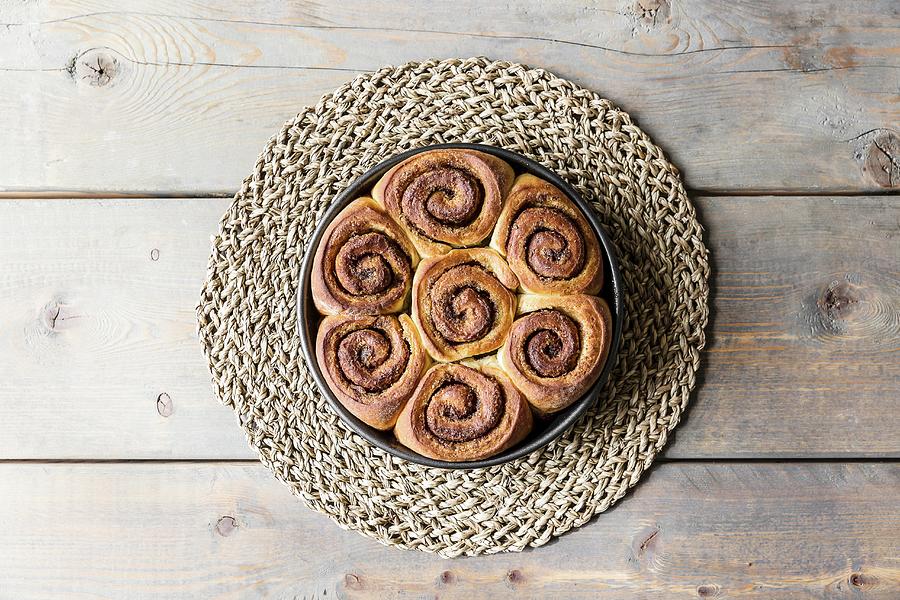 Cinnamon And Cardomom Buns In A Pan On A Kitchen Table Photograph by Sarah Coghill