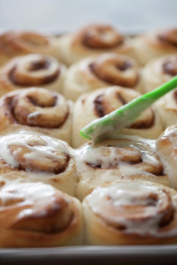 Cinnamon Buns With Pecan Nuts And A Butter Glaze Photograph by Yelena ...