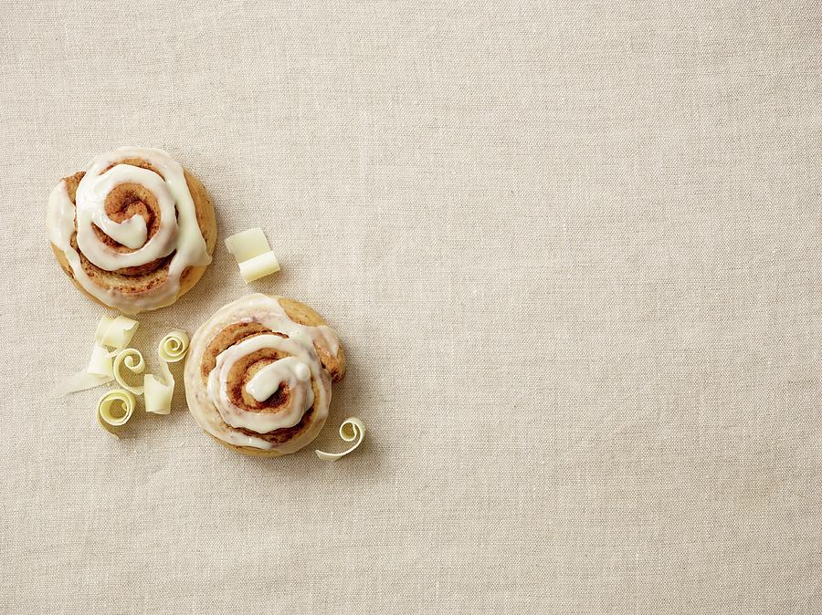 Cinnamon Buns With White Chocolate Photograph by Leigh Beisch