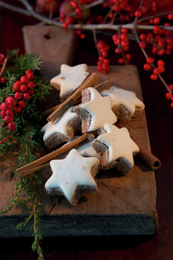 Cinnamon Stars And Cinnamon Sticks On A Wooden Board Photograph by Martina Schindler