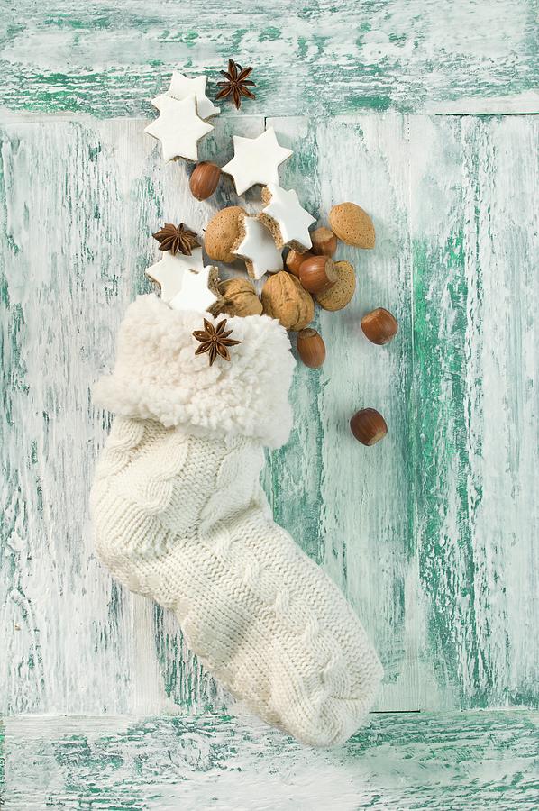 Cinnamon Stars, Nuts And Anise Starts In A Christmas Stocking Photograph by Achim Sass