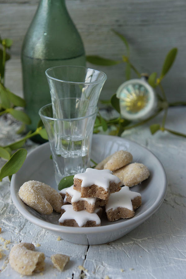 Cinnamon Stars, Vanilla Crescent Biscuits And Shot Glasses On A Plate Photograph by Martina Schindler