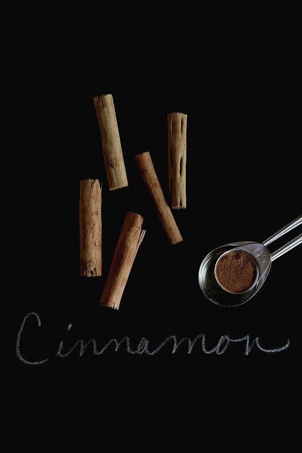 Cinnamon Sticks And Ground Cinnamon With A Label Photograph by Vfoodphotography