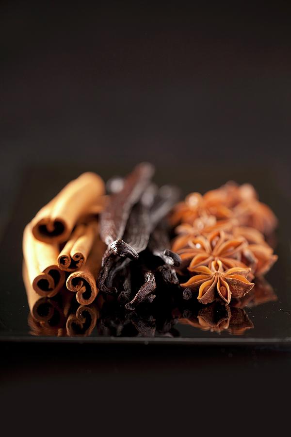 Cinnamon Sticks, Vanilla Pods And A Star Anise Photograph by Bertrand Limbour