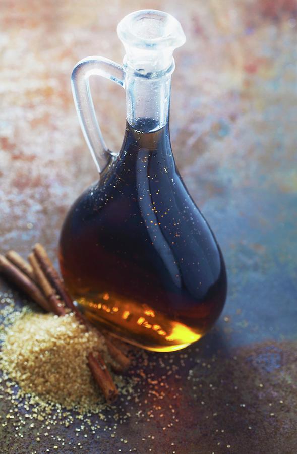 Cinnamon Syrup In A Bottle On A Metal Surface Photograph by Barbara ...