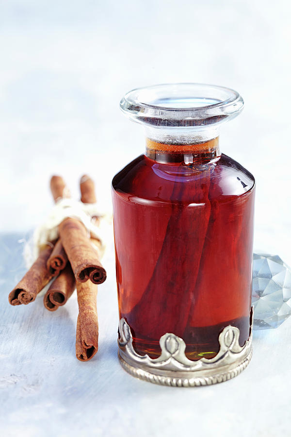 Cinnamon Syrup In A Decorative Carafe With Whole Cinnamon Sticks Photograph by Teubner Foodfoto