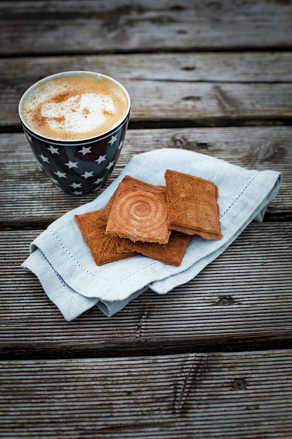 Cinnamon Waffles With A Cappuccino On A Piece Of Greaseproof Paper Photograph by Tina Engel