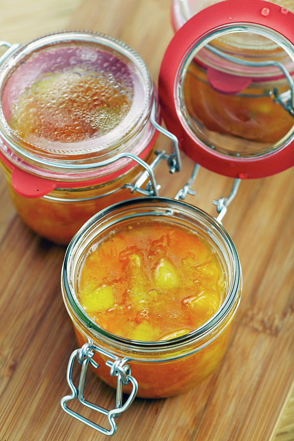 Citrus Fruit Marmalade In Preserving Jars Photograph by Herbert Lehmann