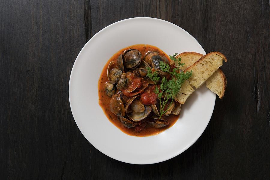 Clams In A Spicy Tomato Broth With Crostini Photograph by Angelika Grossmann