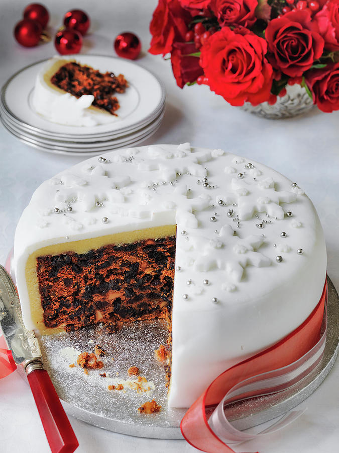 Classic Fondant Iced Christmas Cake Cut Into With Slice Photograph by Michael Paul
