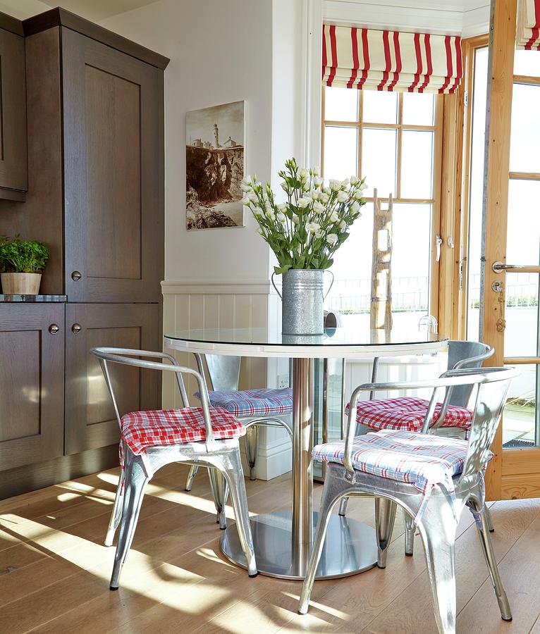 Classic, Metal Chairs And Round Table In Front Of Open Terrace Door With Red And White Striped Roman Blinds On Windows Photograph by Tim Imri