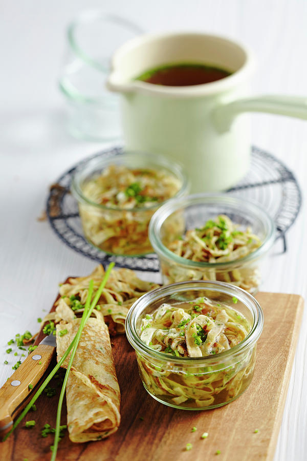 Clear Meat Broth In Jars Served With Pancake Strips Photograph by Teubner Foodfoto