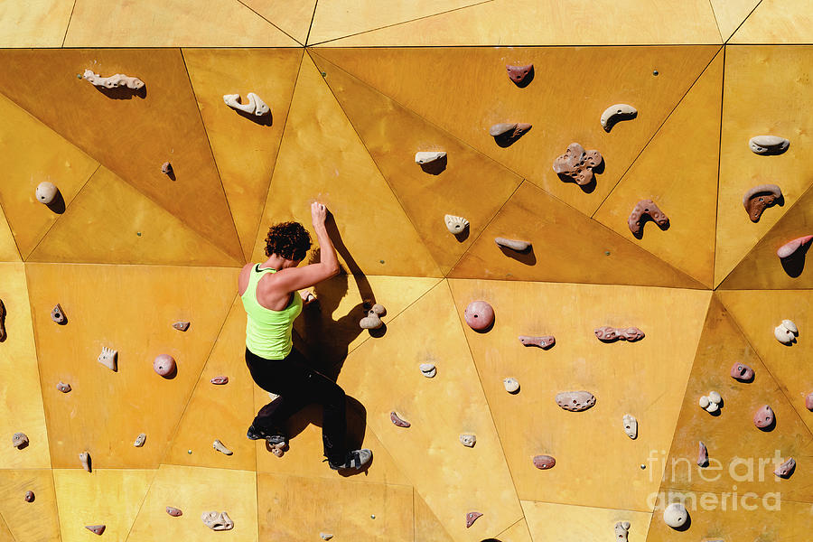 Climbing wall with strong woman in good shape doing exercise outdoors Photograph by Joaquin Corbalan