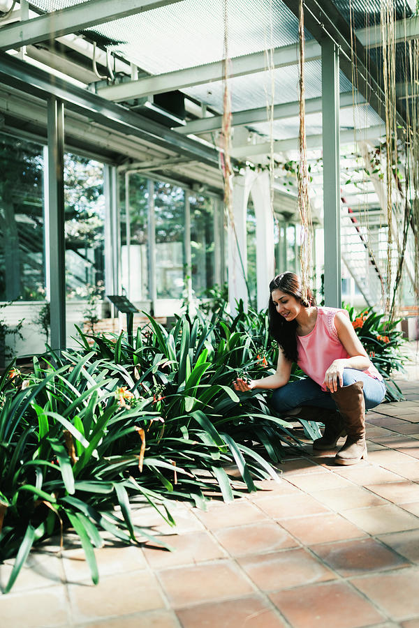 Nature Photograph - Close Up Of A Beautiful Agronomical Engineer Observing The Plants In The Greenhouse by Cavan Images
