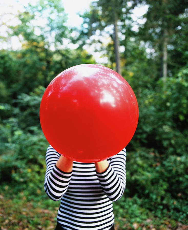 Close-up Of A Woman Blowing A Balloon Photograph by Panoramic Images