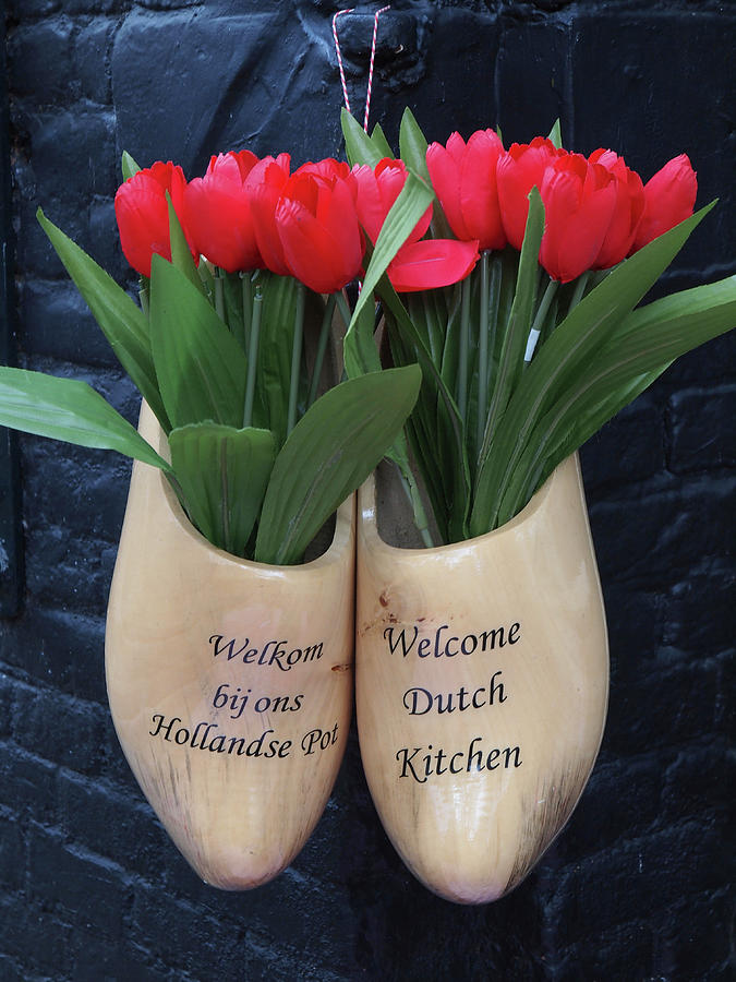 Close-up Of Clogs With Tulips At Bistro Bij Ons, Amsterdam, Netherlands Photograph by Jalag / Marion Beckhuser