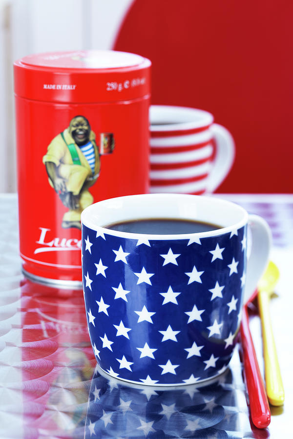 Close-up Of Cup With Stars And Stripes With Coffee Sleeve Photograph by Jalag / Franziska Taube