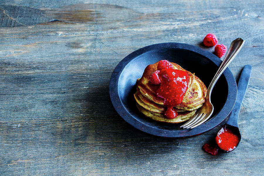 Close Up Of Freshly Made Pancakes With Raspberry Jam And Fresh Raspberries In Rustic Wooden Bowl For Breakfast Photograph by Yuliya Gontar