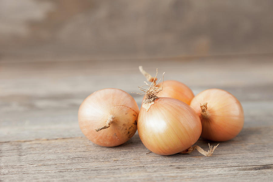 Close Up Of Onions On Table Photograph by Stefanie Grewel