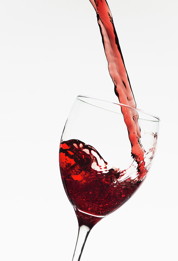 Close Up Of Red Wine Being Poured Into Photograph by Tetra Images