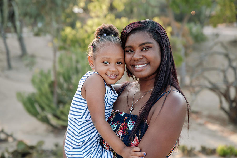 Close-up Portrait Of Happy Aunt Carrying Girl While Standing Against ...