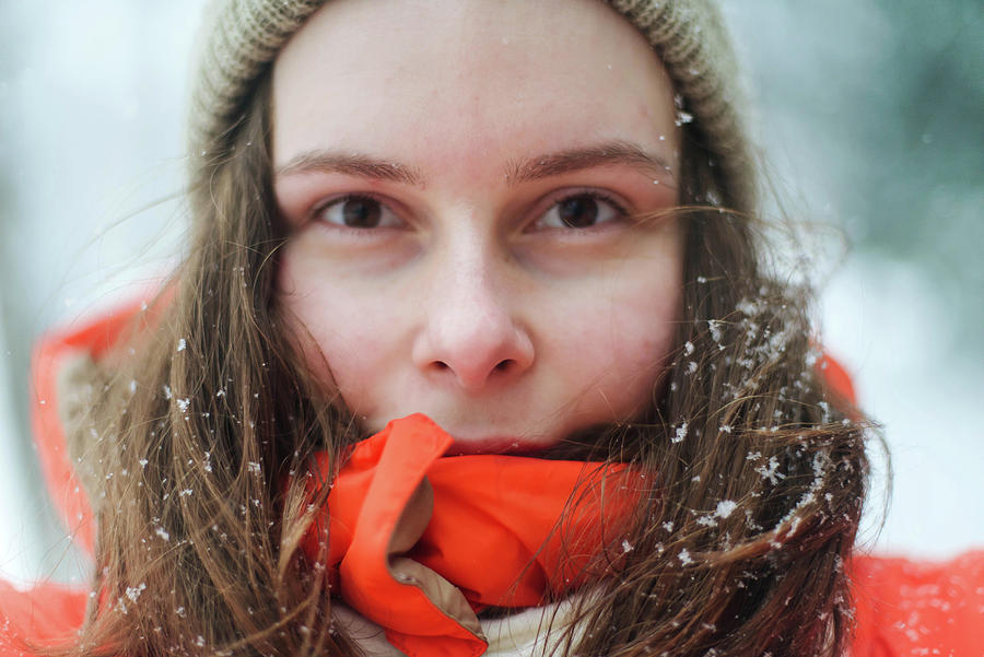 Close Up Portrait Of Woman In Orange Jacket During Winter In The Photograph By Cavan Images