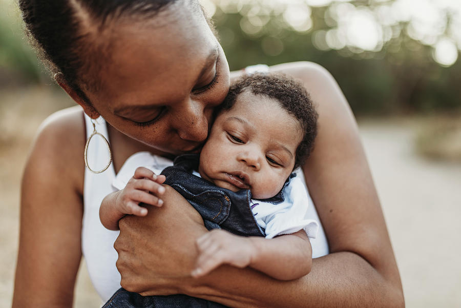 Close Up Portrait Of Young Mother Holdiing Infant Daughter Outside Photograph by Cavan Images