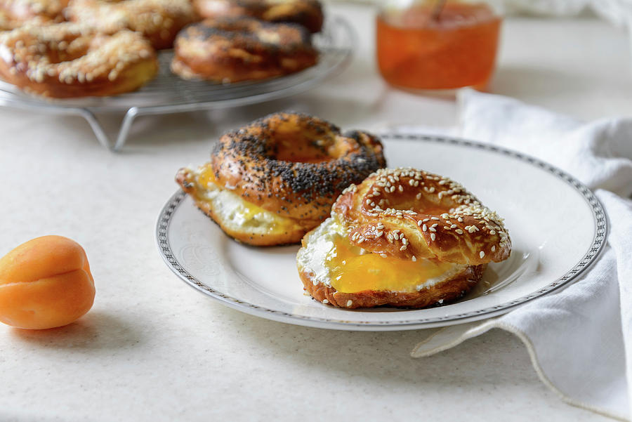 Closeup View Of Freshly Baked Bagels With Apricot Jam Filling Photograph by Albina Bougartchev