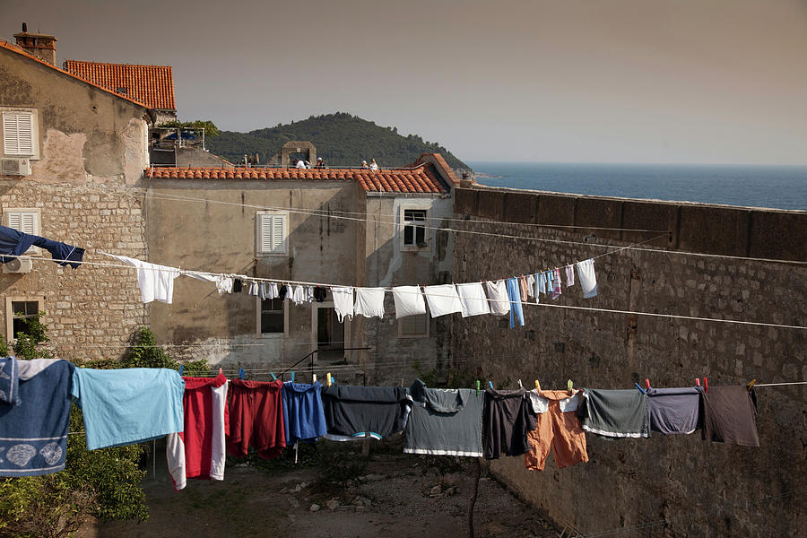 Architecture Digital Art - Clothes Hanging From Lines On Rooftops by Walter Zerla