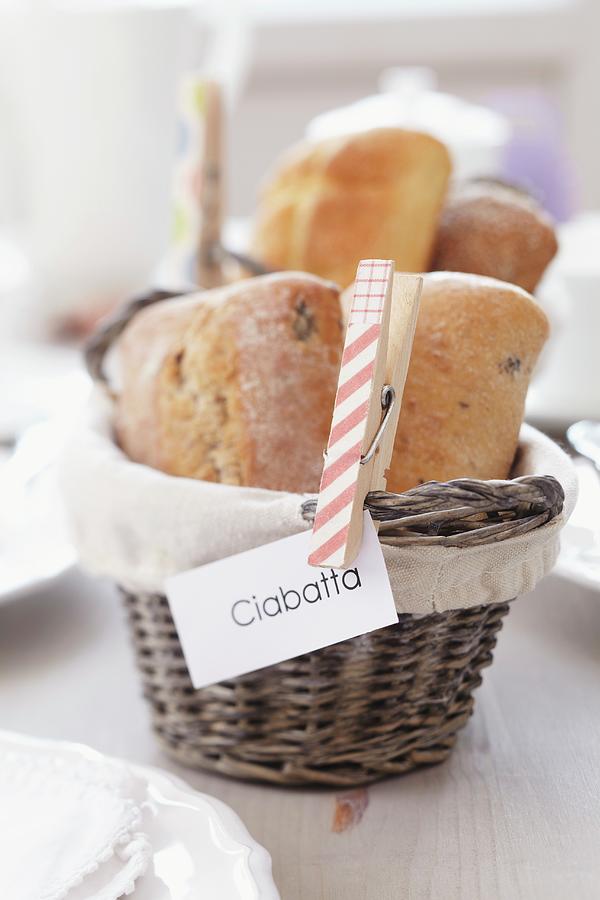 Clothes Peg Holding Sign On Bread Basket Photograph by Franziska Taube