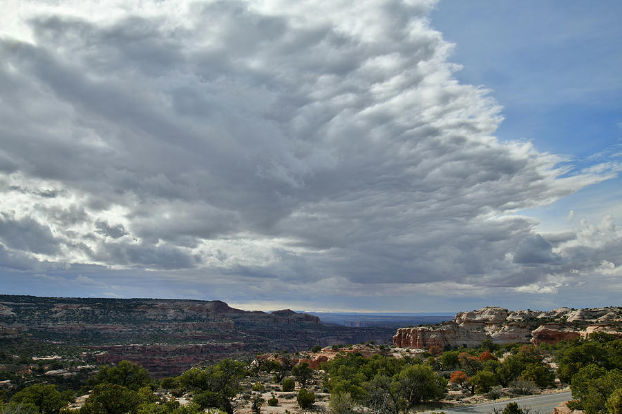 Clouds over the Neck in Canyonlands National Park Photograph by Ray Mathis