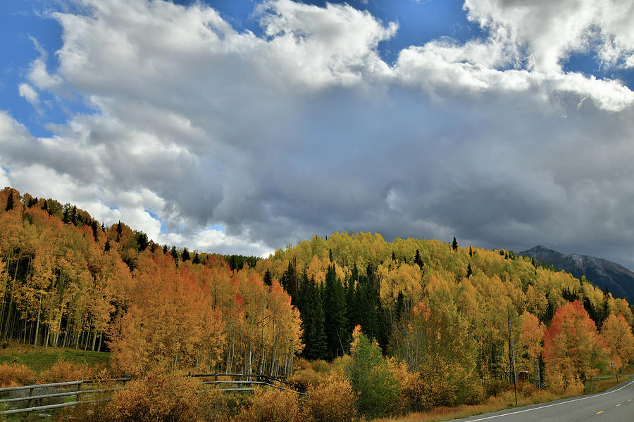 Clouds Pass Over Hills of Colorful Aspens Photograph by Ray Mathis