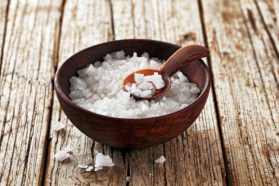 Coarse Sea Salt In A Wooden Bowl With A Spoon Photograph by Petr Gross