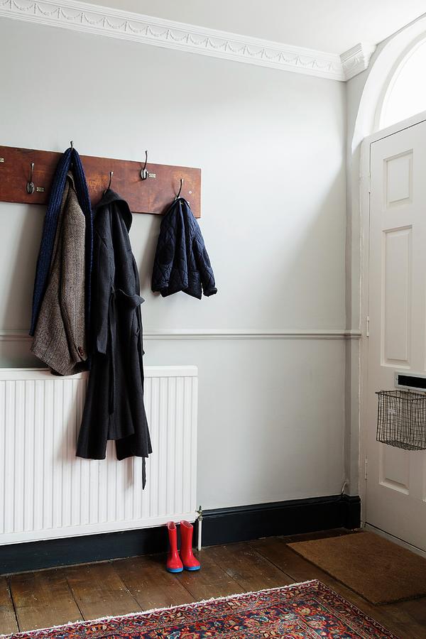 Coat Rack Made From Old Plank In Hallway With Dado Rail And Stucco Frieze Photograph by Rikard Osterlund