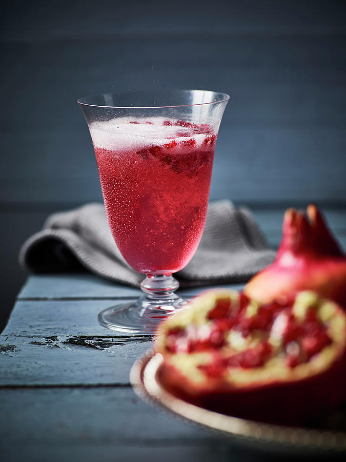 Cocktail Made With Pomegranate And Sparkling Wine Photograph by Peter Rees