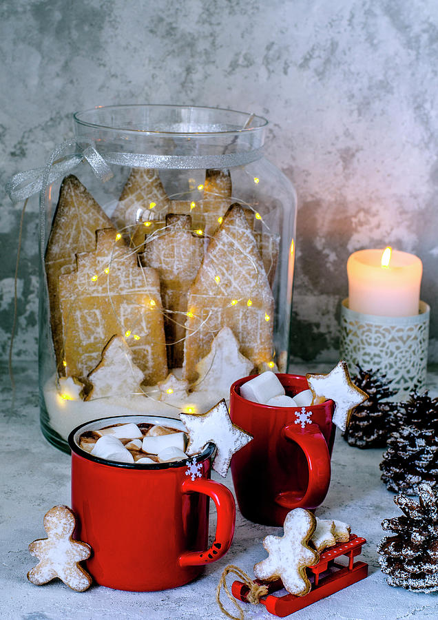 Cocoa In Red Cups With Marshmelow, Gingerbread Men And Gingerbread City In A Glass Jar In Christmas Style Photograph by Gorobina